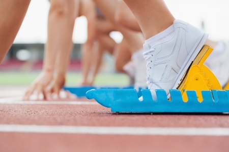 15589874 - athletic starting block with runners on track